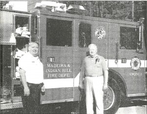 Robert Coy (left), chief of the Madeira and Indian Hill Fire Department, and Dan McDonald, president of the board of trustees, proudly display the department's new pumper, Engine No. 2.